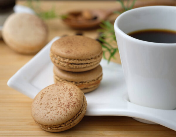 Hazelnut flavored coffee in a cup next to hazelnut cookies