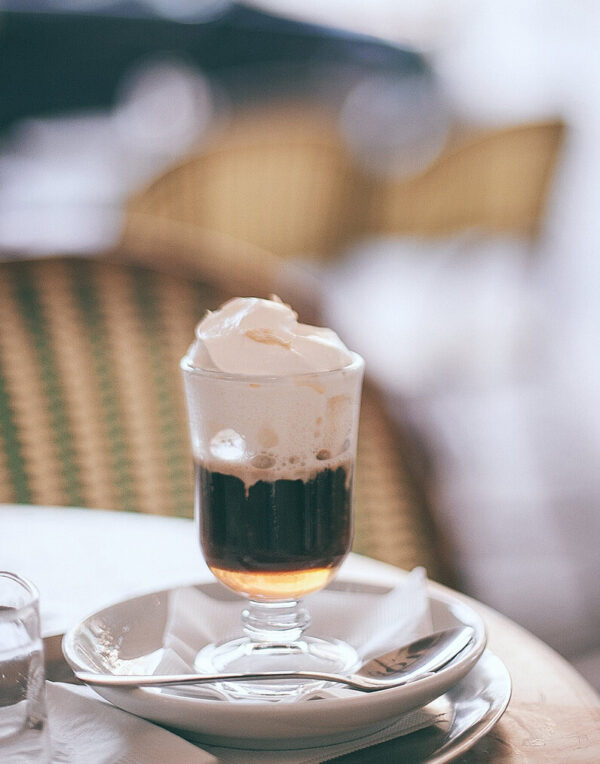 Irish Cream flavored coffee in a glass mug with whipped cream on top