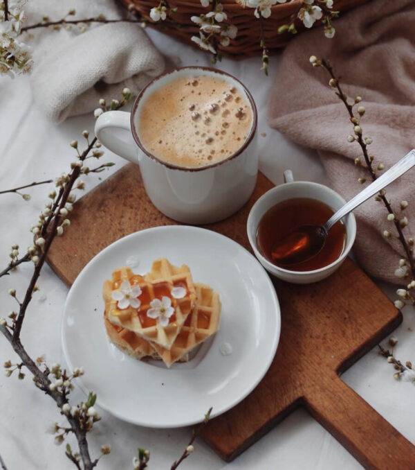 Vermont Maple Nut flavored coffee on a tray with waffles and maple syrup