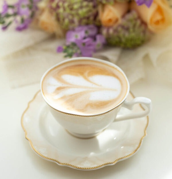 White Chocolate Mousse flavored coffee in a china tea cup on a saucer