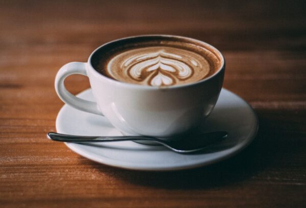 Jamaican Me nuts flavored coffee in a cup with a foam design on top